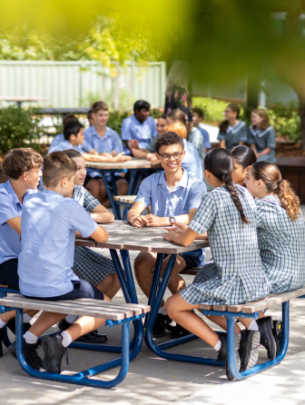 Children sitting a table outside